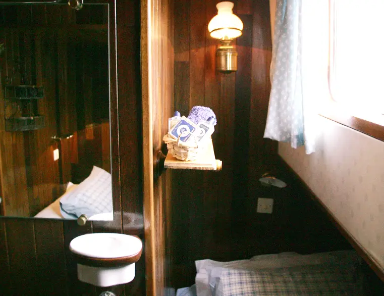 Twin cabin aboard a small luxury hotel barge.