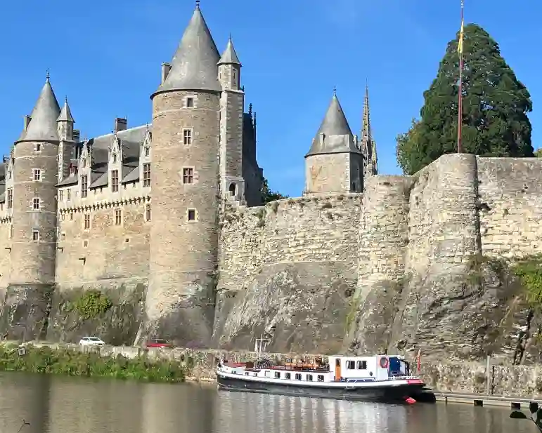 Hotel barge moored outside Josselin castle