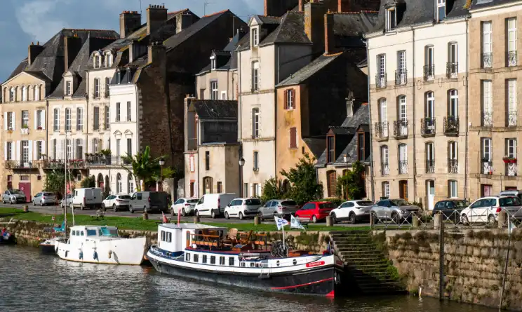 Hotel barge moored in a pretty French town in Brittany.