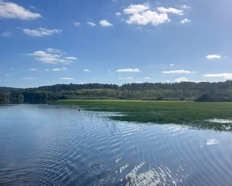 View of the river in inland Brittany showing the bue sky reflecting on the water.
